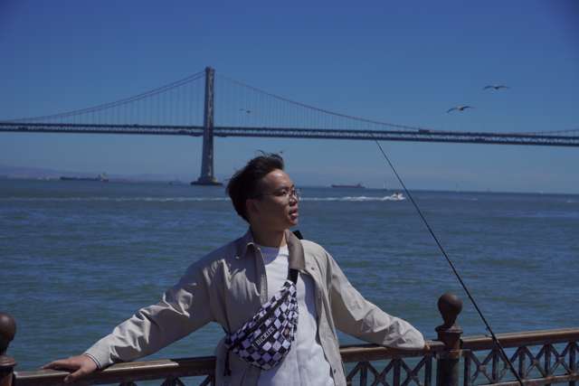 Jiajun Xia in San Francisco with the Bay Bridge in the background